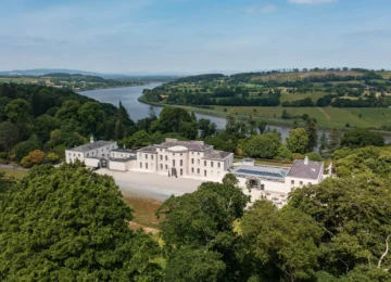 Luxurious countryside hotel with scenic river views, surrounded by lush greenery, offering tranquil retreats.