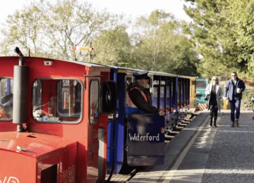 Guests enjoy a scenic ride on Waterford’s vintage train through lush greenery and serene pathways at the hotel resort.