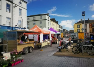 Bustling outdoor market with colourful stalls